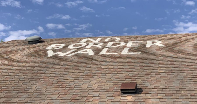 No Border Wall painted on a roof in South Texas